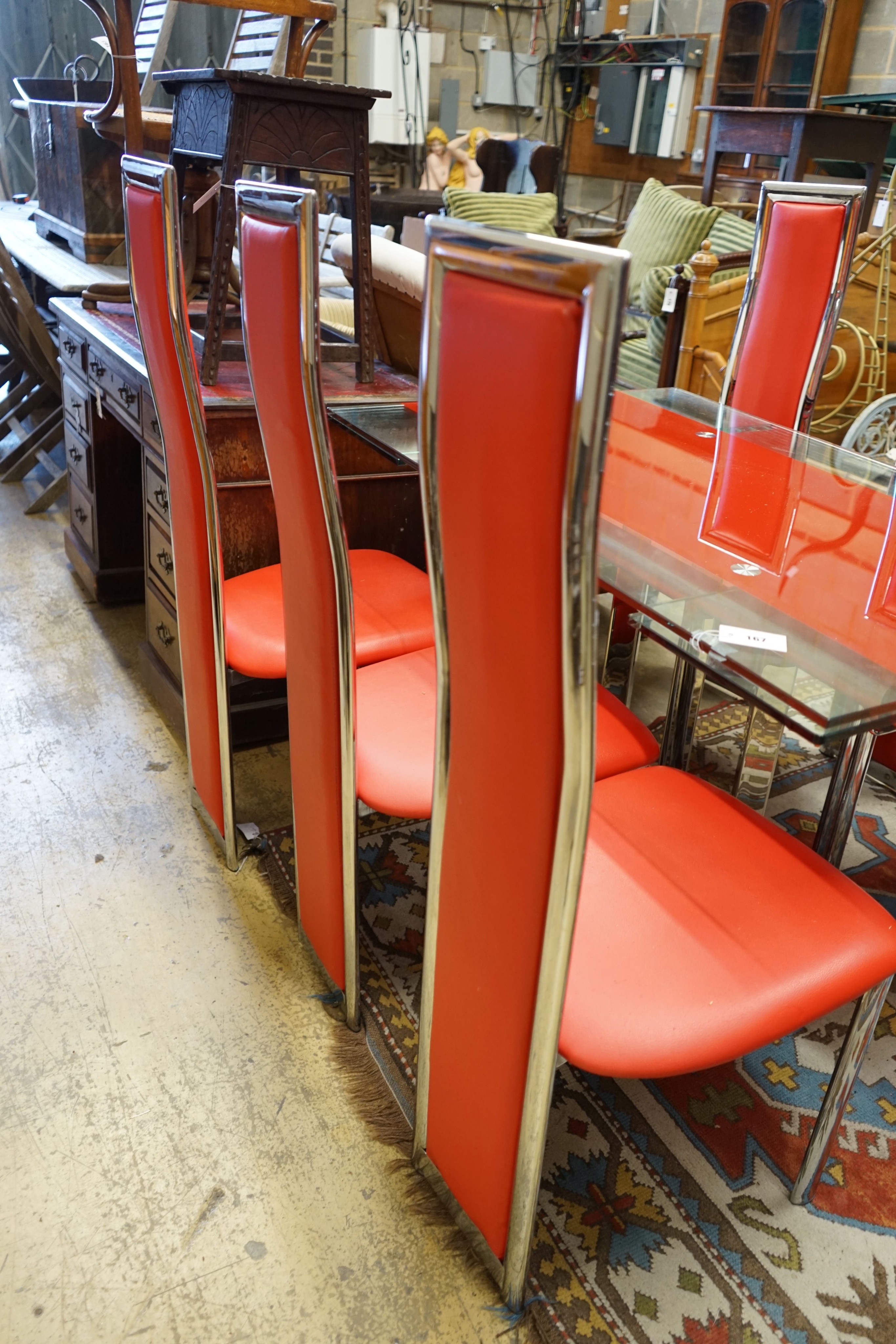 A set of red Italian design dining chairs and an associated chrome table, width unextended 120cm depth 80cm height 75cm